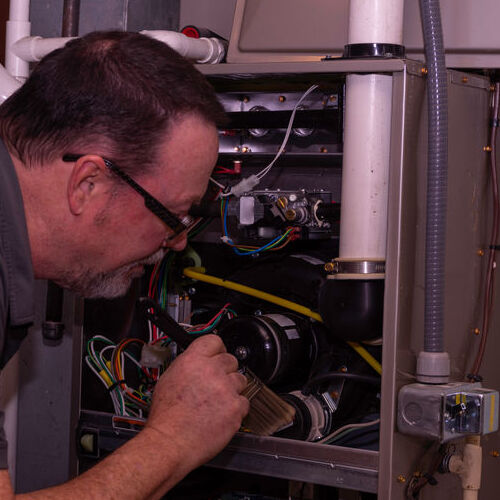 Technician makes emergency furnace repair.
